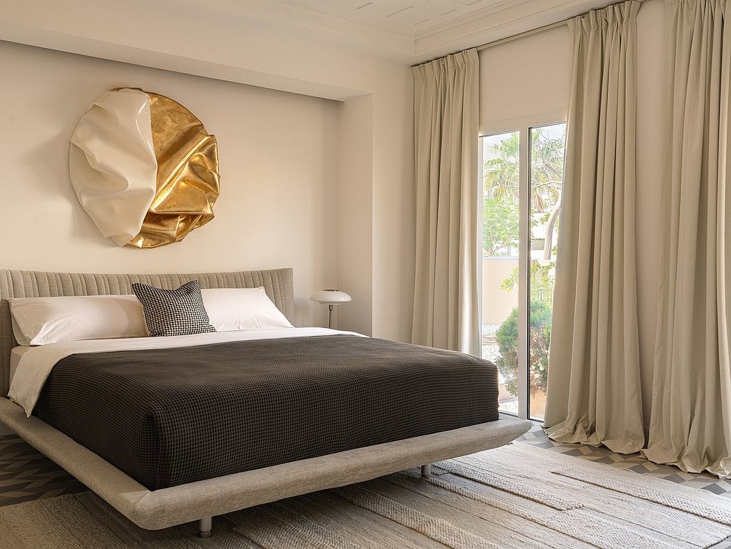 Sophisticated bedroom with plush bedding, gold-accented artwork, and expansive windows.