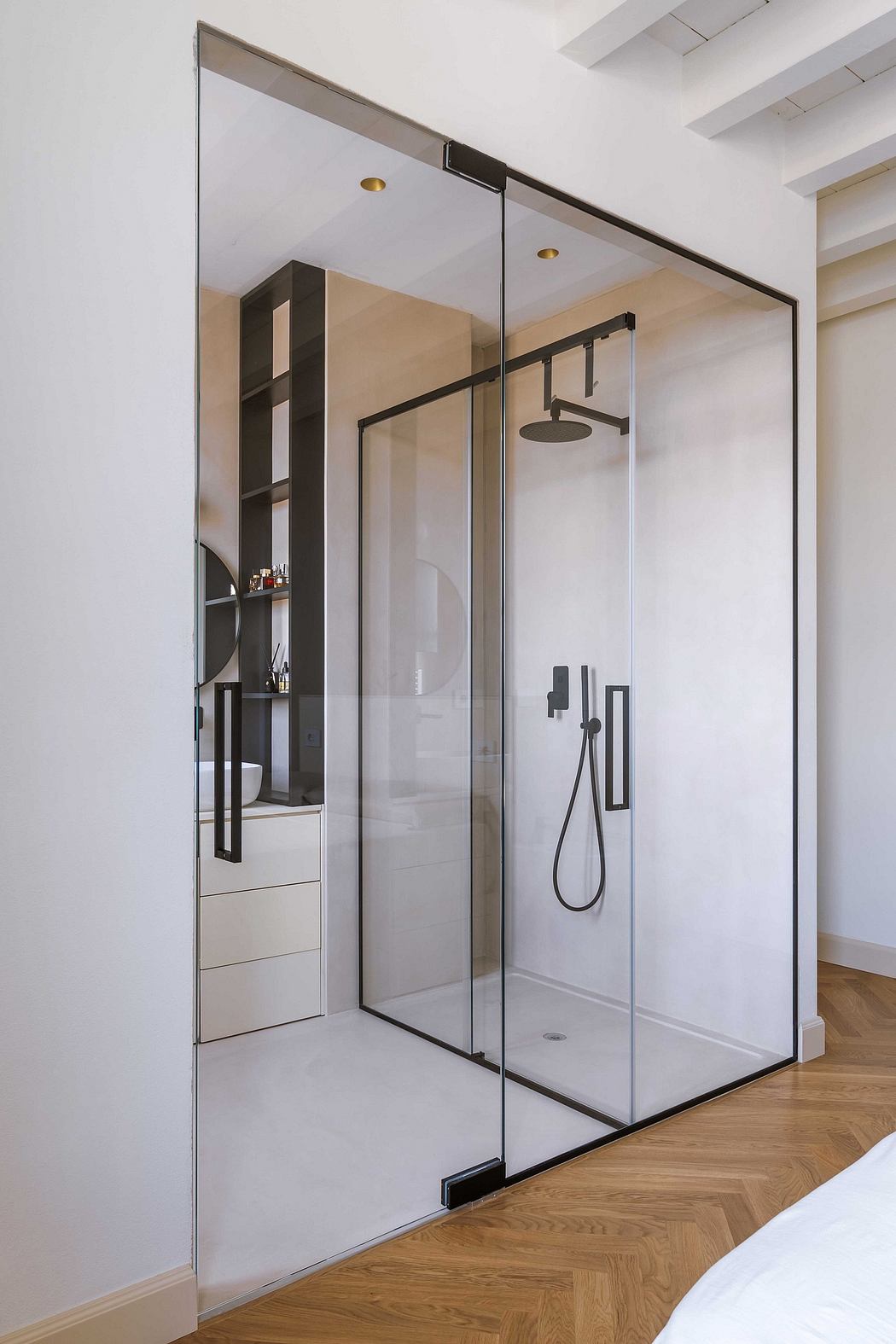 Modern shower enclosure with sleek black metal frame, glass panels, and built-in shelving.