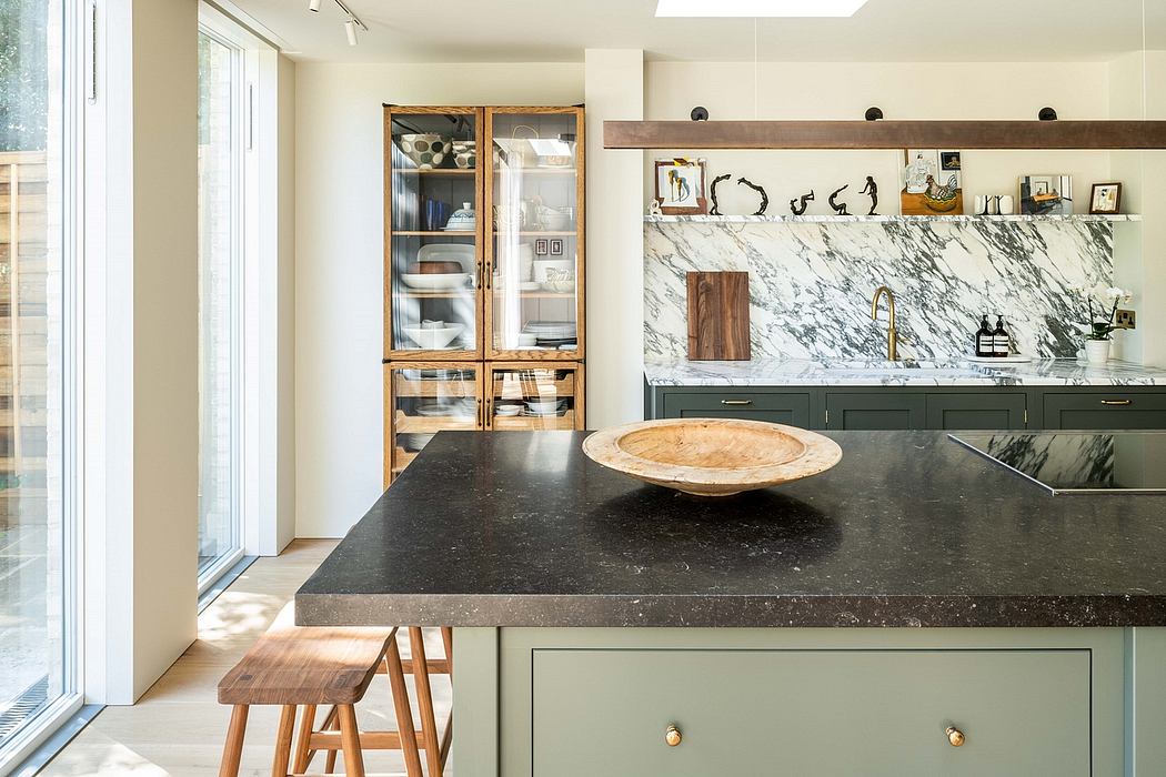 Sleek modern kitchen with marble countertops, wooden cabinetry, and a unique sculptural centerpiece.
