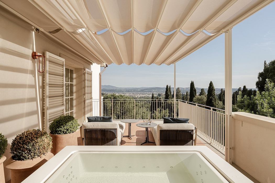 Elegant outdoor space with retractable canopy, lounge seating, and panoramic mountain views.