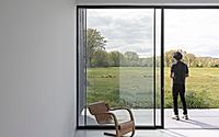 013-weald-house-mirrors-remote-kent-meadows-with-sleek-roof-tiles.jpg
