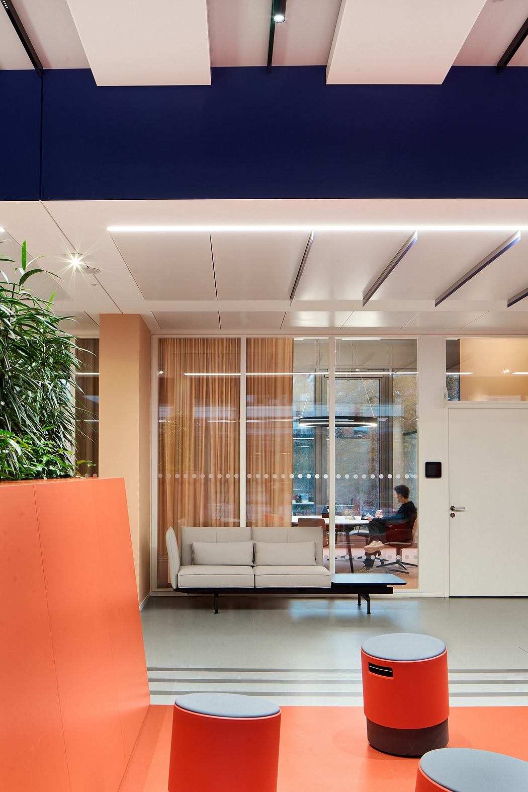 Minimalist office with vibrant accents, sleek modern furnishings, and natural lighting.