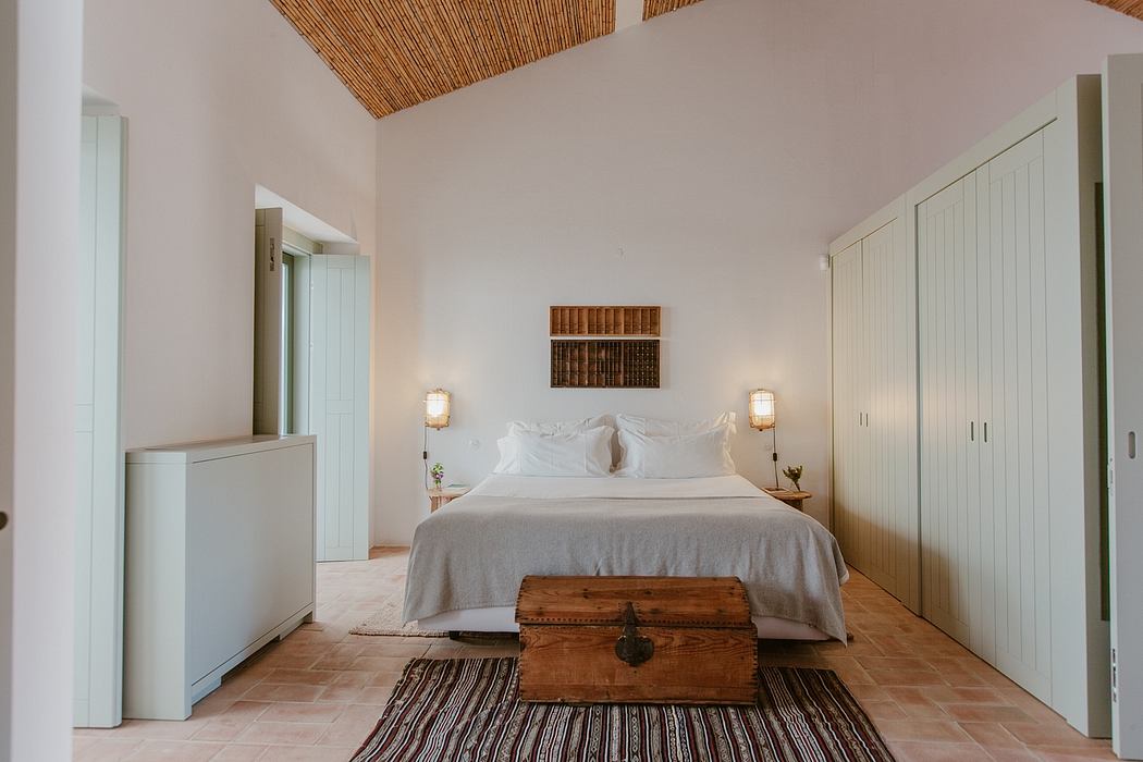 Stylish bedroom with vaulted ceiling, wooden accents, and antique chest.