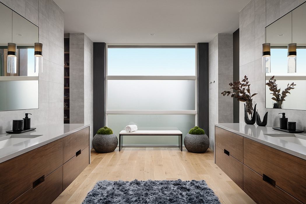 Spacious, minimalist bathroom design with large window, wood cabinetry, and natural decor.