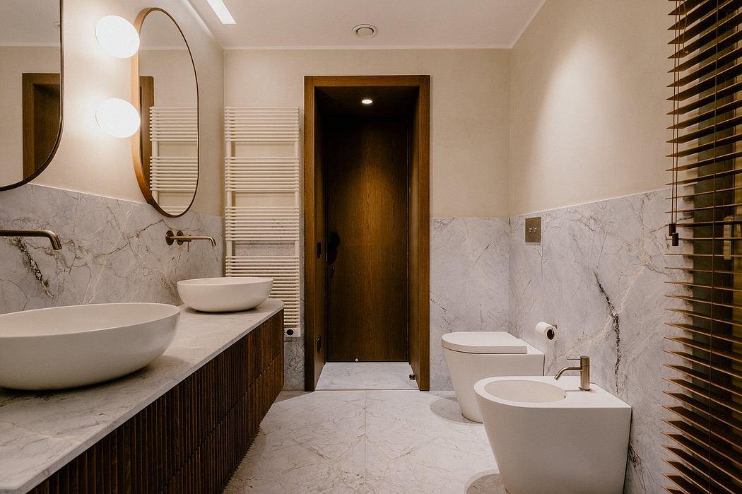 Sleek modern bathroom with minimalist design, marble walls, and wood vanity.