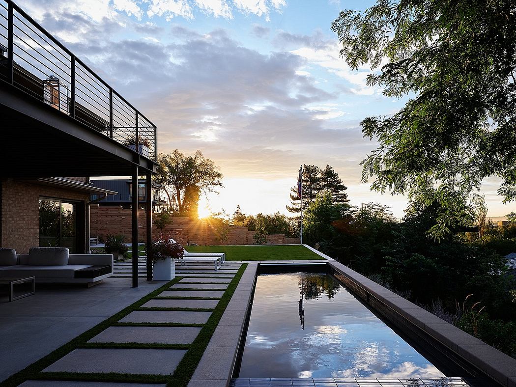 Stunning modern outdoor space with a reflecting pool, paved walkway, and lush greenery.