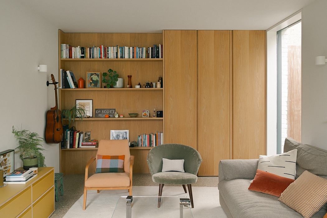 Cozy living room with built-in wooden shelves, comfortable seating, and warm decor.