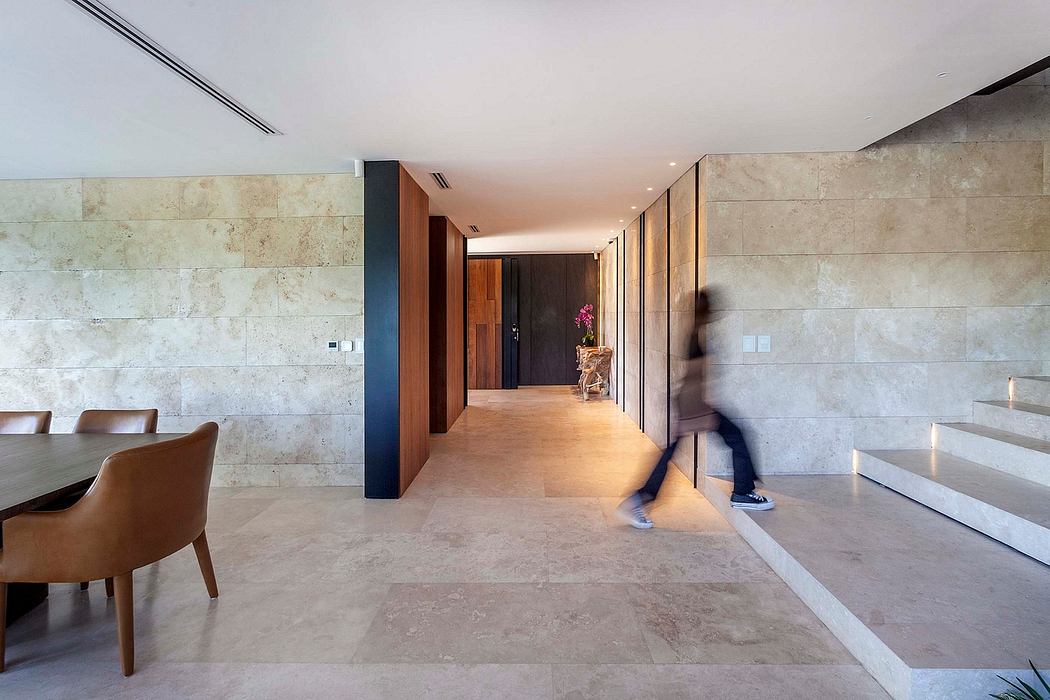 Minimalist interior design with travertine wall tiles, wooden accents, and recessed lighting.