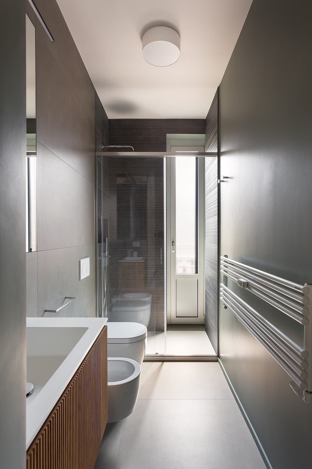 A modern, minimalist bathroom with clean lines, a glass shower, and textural accents.