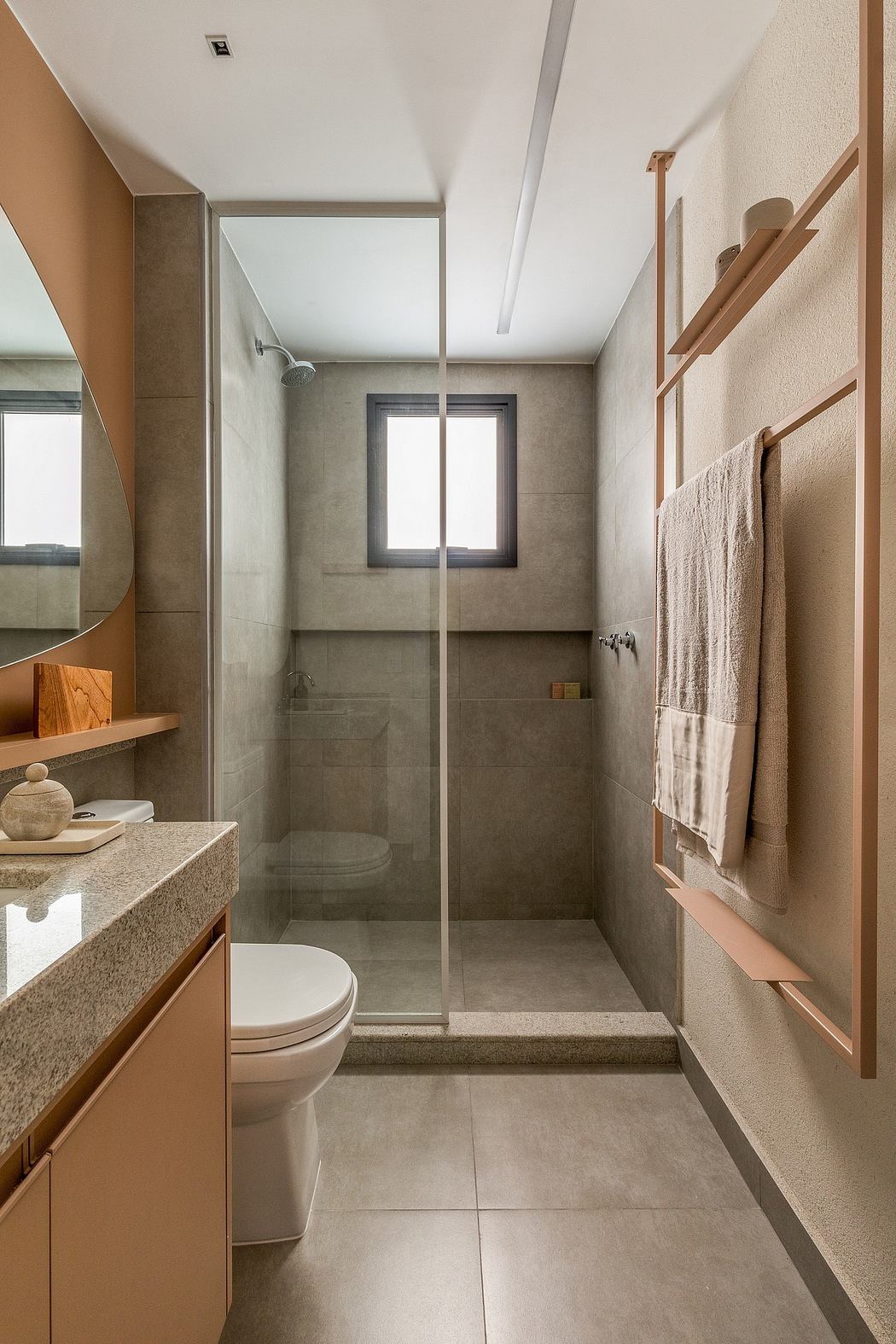 Elegant bathroom with minimalist design, featuring a glass shower, wooden accents, and a granite vanity.