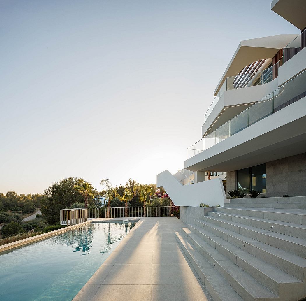 Modern residential building with sleek architectural features and a swimming pool.