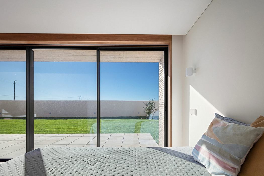 Large windows provide a panoramic view of the lush, grassy yard outside.