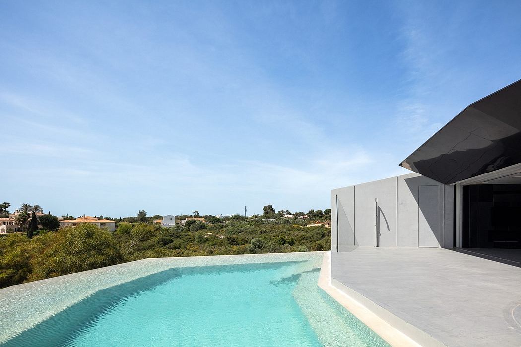 Sleek architectural design with a modern, minimalist pool overlooking lush greenery.