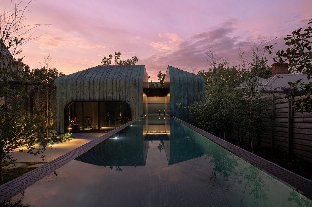 Striking modern architecture with a tranquil reflection pool at sunset.