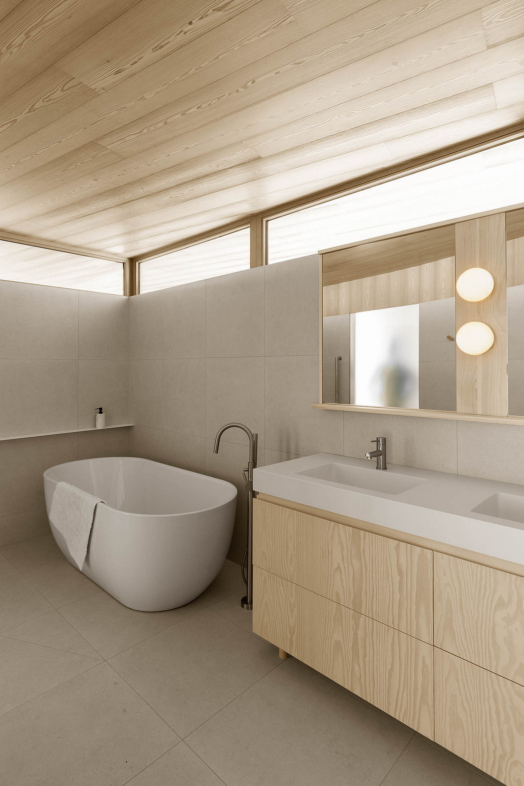 Minimalist bathroom with freestanding tub, wooden vanity, and recessed lighting.