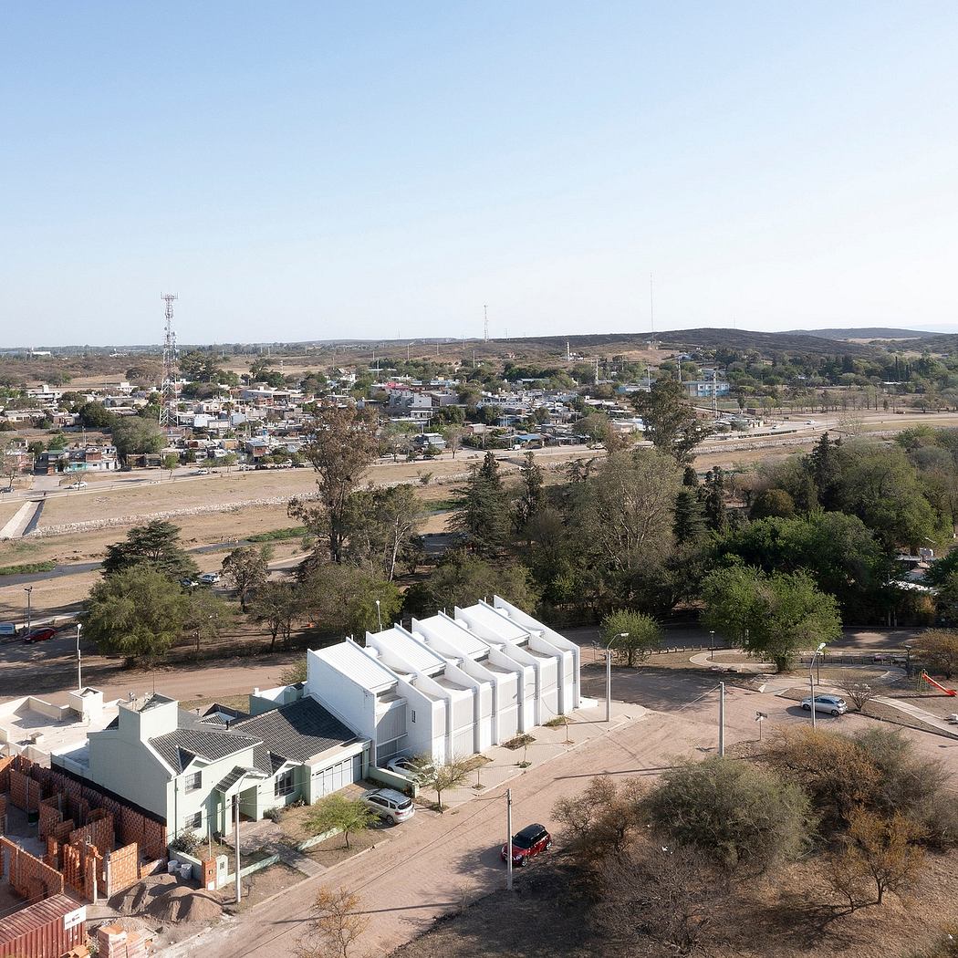 A small town nestled in a hilly landscape, with a mix of modern and traditional architecture.