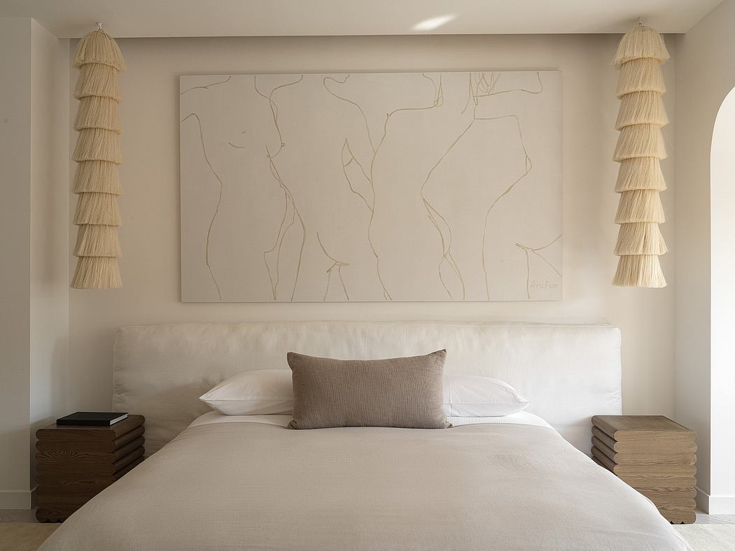 A serene and minimalist bedroom design featuring neutral tones, textured artwork, and elegant lighting.