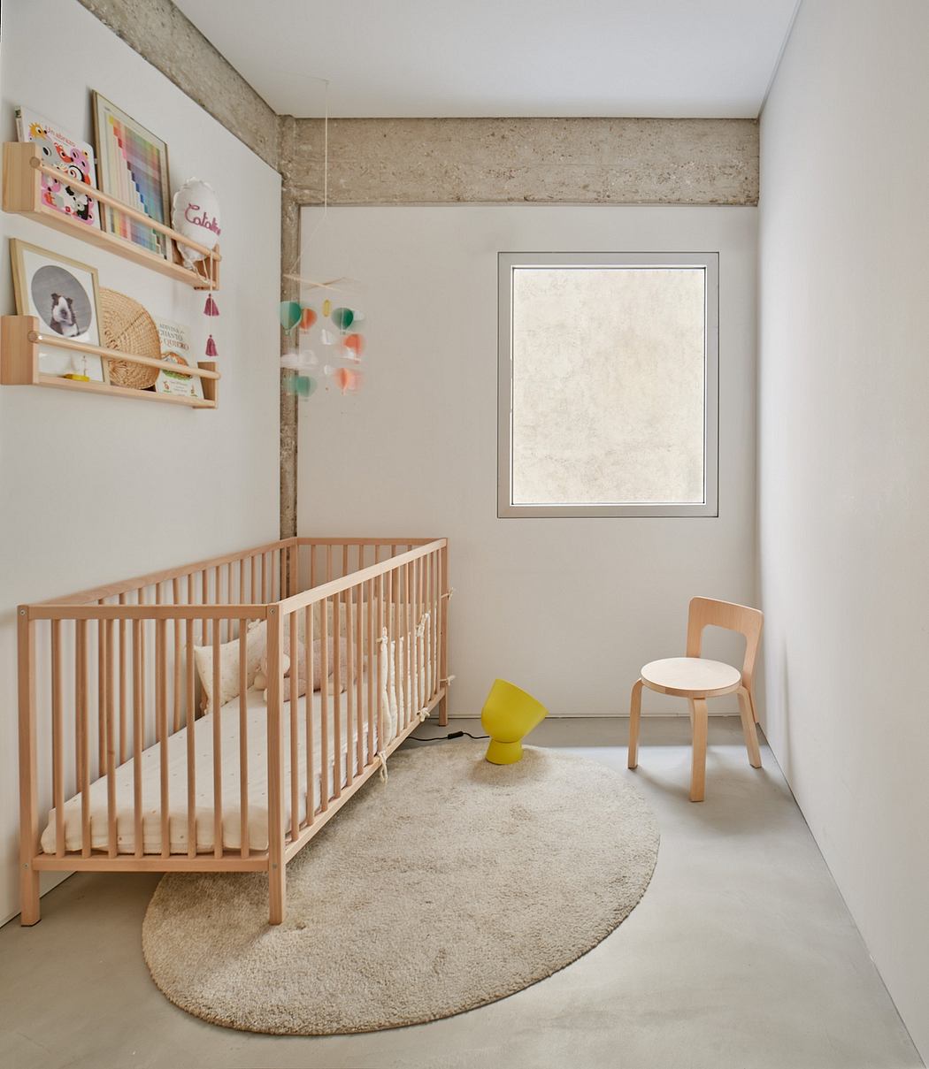 Cozy nursery space with neutral color palette, wooden crib, and modern furniture.
