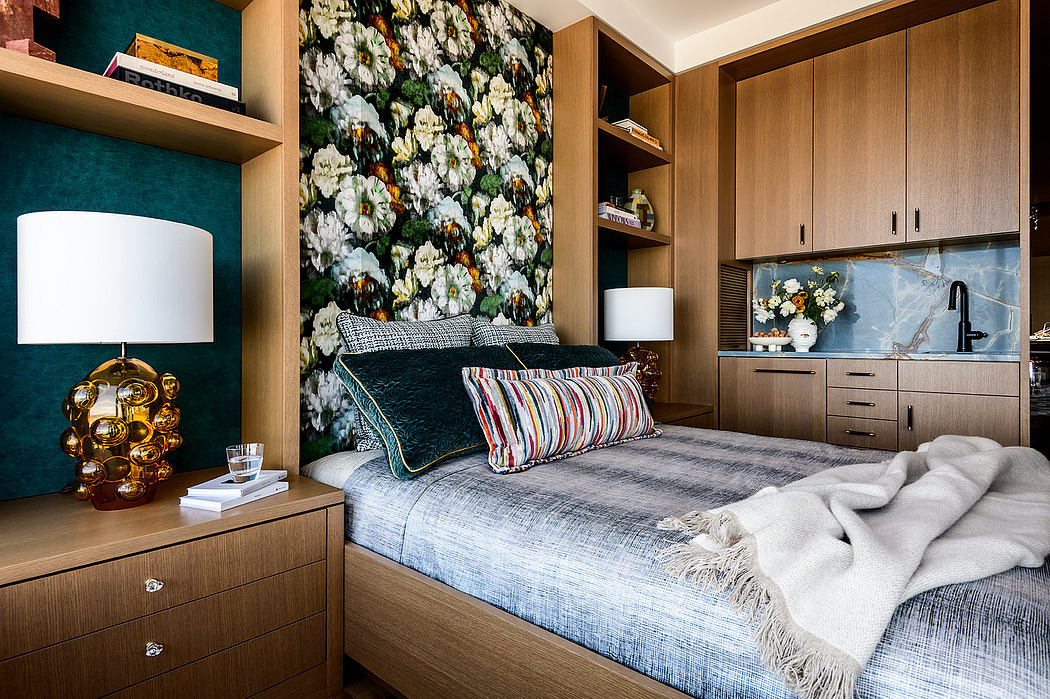 Cozy bedroom with floral wallpaper, wooden furniture, and warm lighting, creating a stylish ambiance.