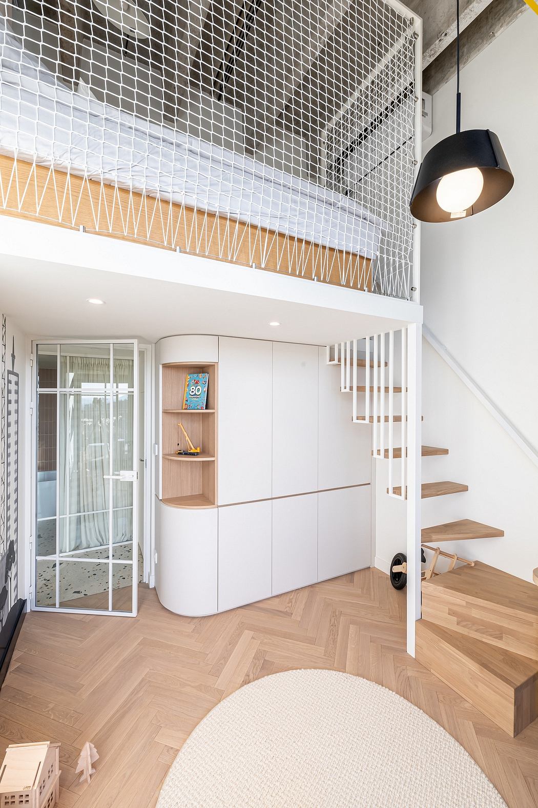Minimalist apartment design with geometric-patterned railing, built-in storage, and natural wood flooring.