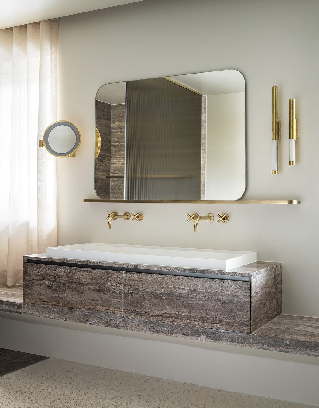 A modern bathroom with a minimalist, angular design featuring natural stone vanity.