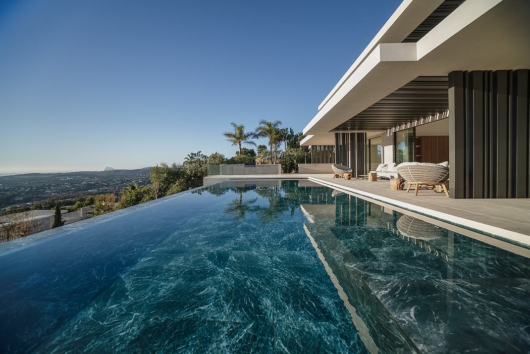 Sleek modern architecture with an infinity pool overlooking a scenic view.