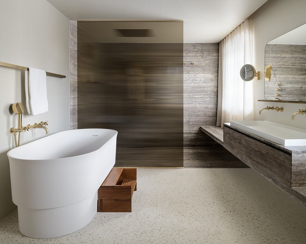 A modern bathroom with a freestanding tub, textured stone walls, and wood accents.