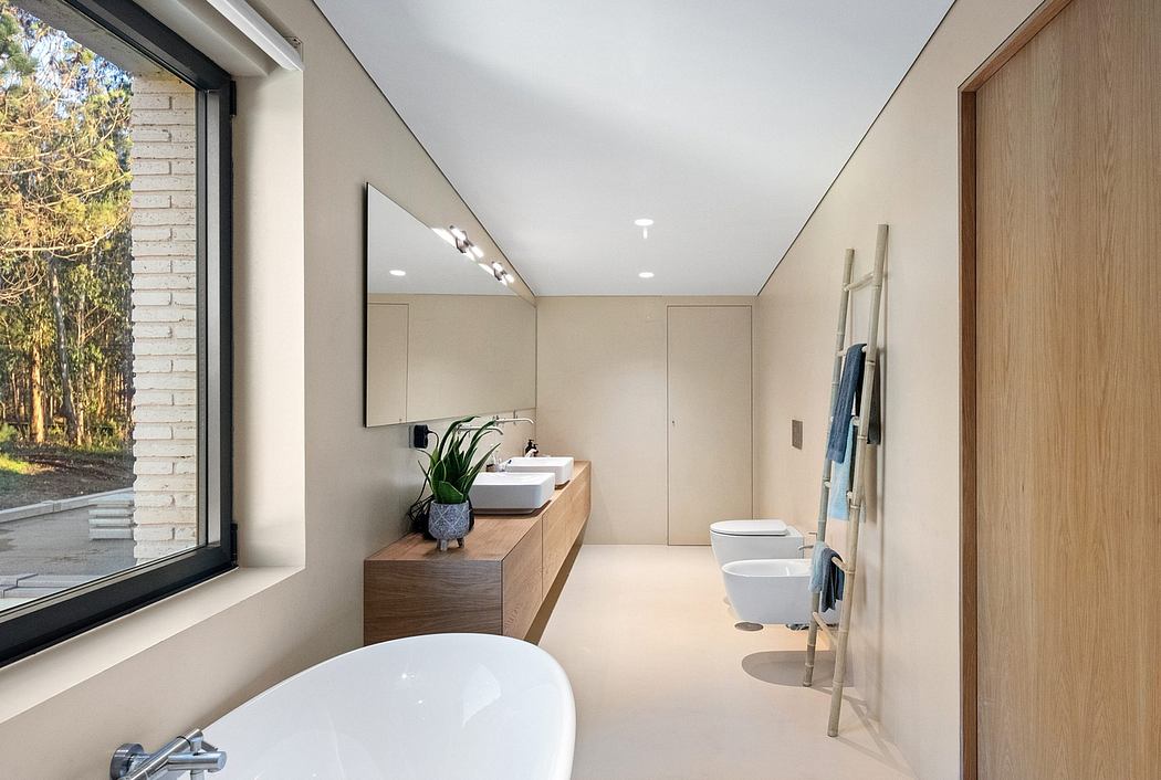 Sleek, modern bathroom features a freestanding tub, vanity, and wood accents.