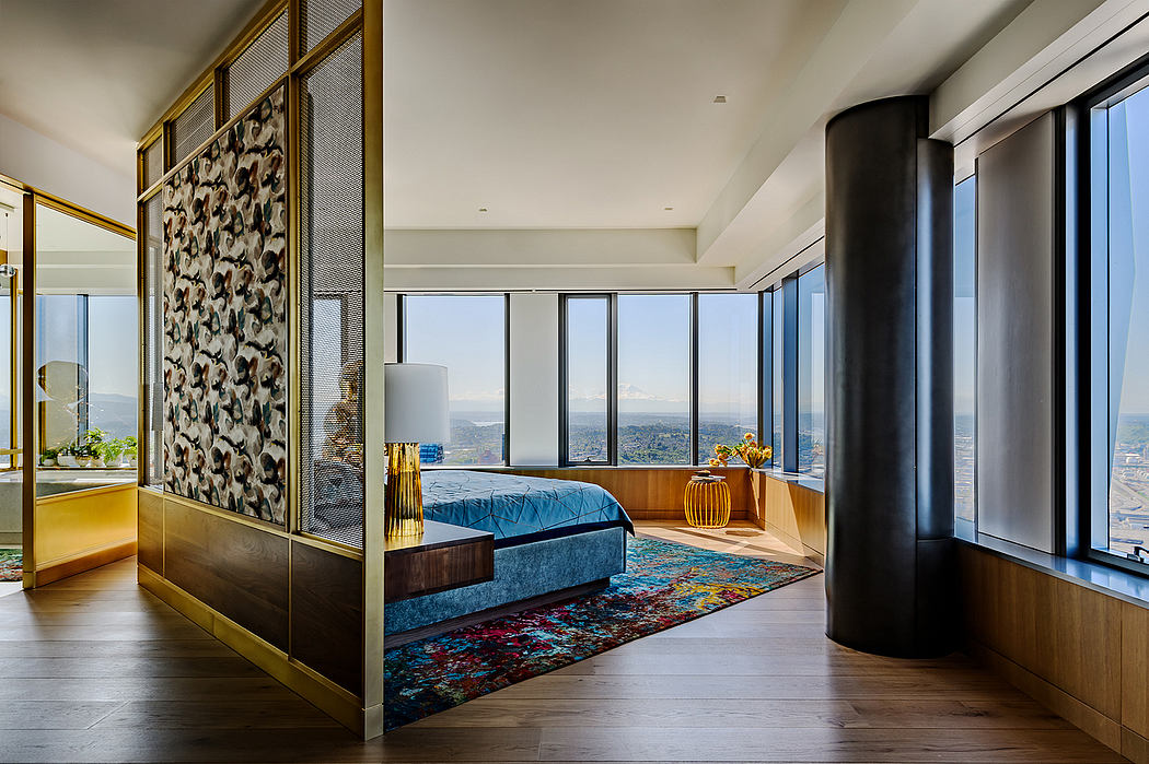 Modern hotel room with expansive windows, colorful textiles, and stylish furnishings.