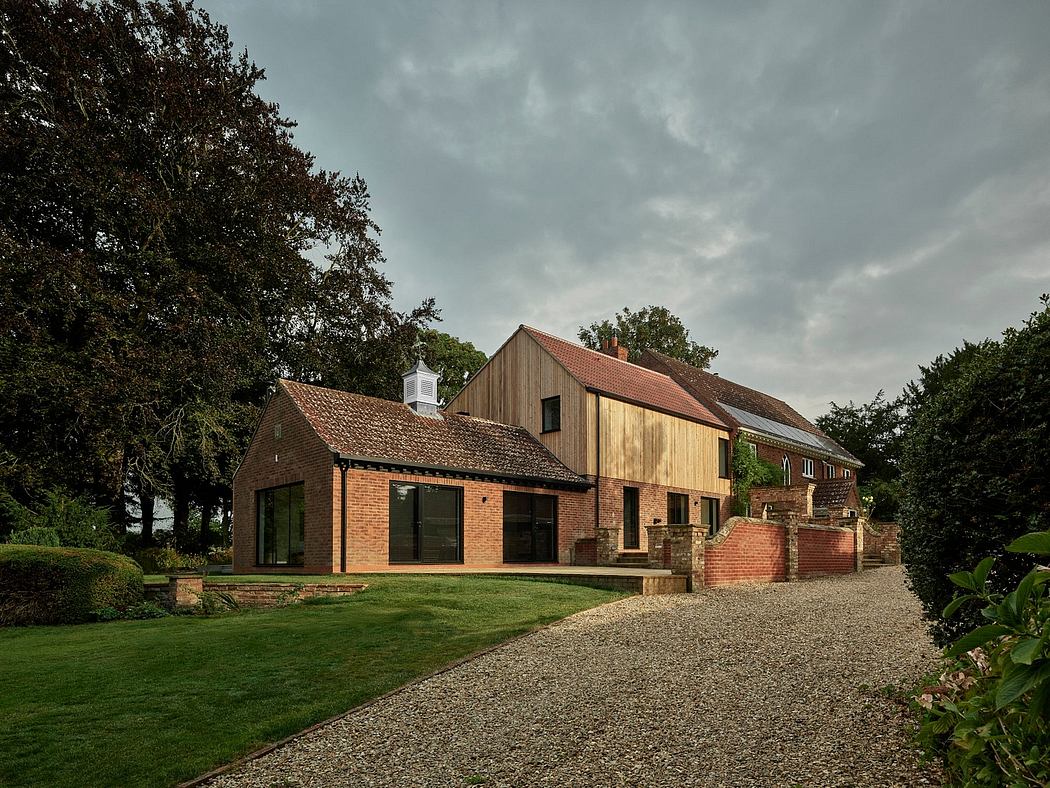 A modern farmhouse-style building with a mix of brick, wood, and glass elements.