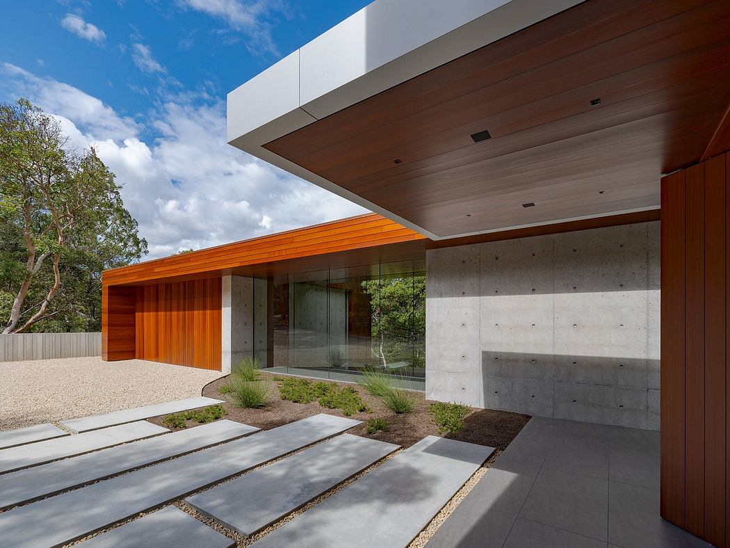 Striking modern architecture with wooden panels, concrete walls, and glass facade.