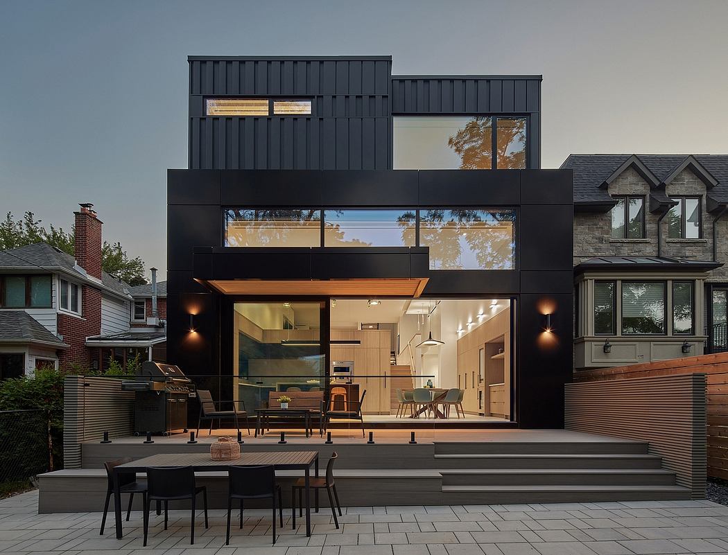 A modern, sleek home with a contrasting exterior of black and wood, offering a spacious, airy interior.