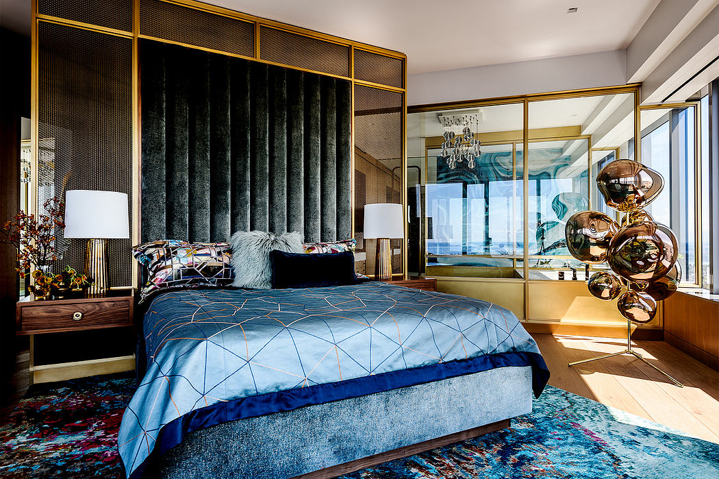 Luxurious bedroom with metallic accents, patterned bedding, and striking lighting fixtures.