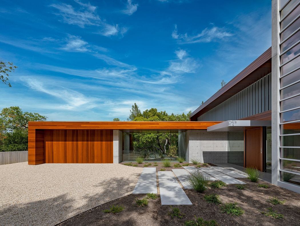 Sleek, modern architecture with wood, concrete, and glass elements. Landscaped exterior.