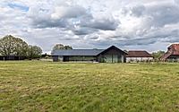 024-weald-house-mirrors-remote-kent-meadows-with-sleek-roof-tiles.jpg