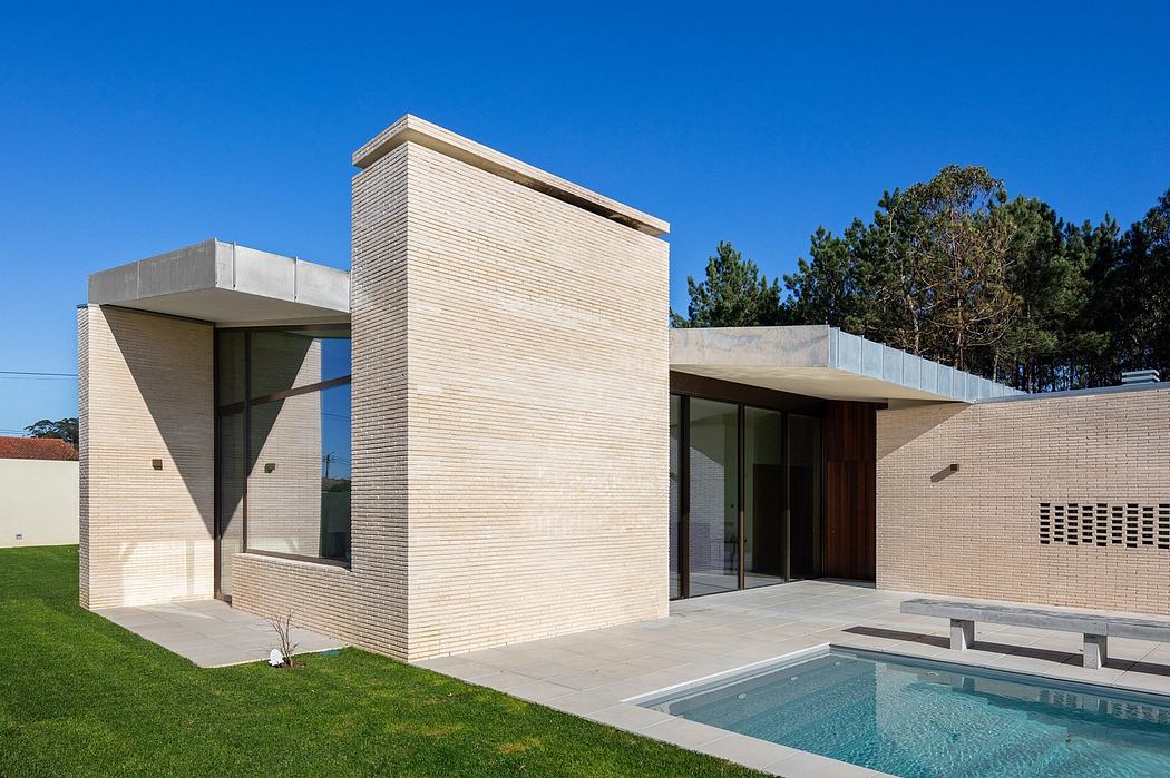 A modern single-story home with clean lines, large windows, and a swimming pool.