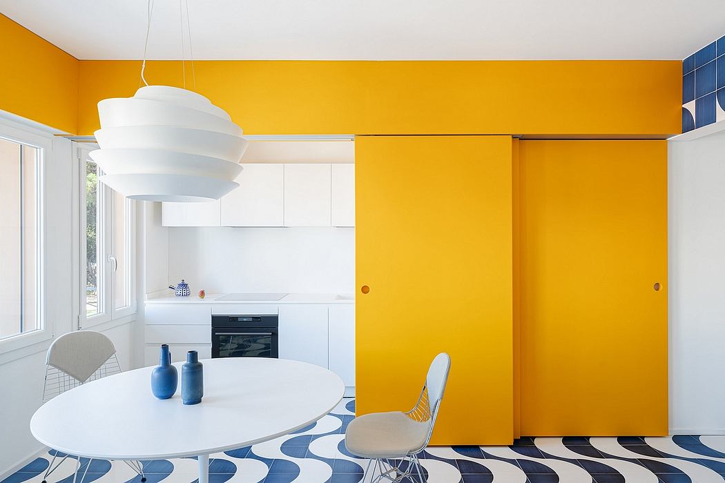 A vibrant yellow and blue color scheme with a modern, minimalist kitchen and dining area.