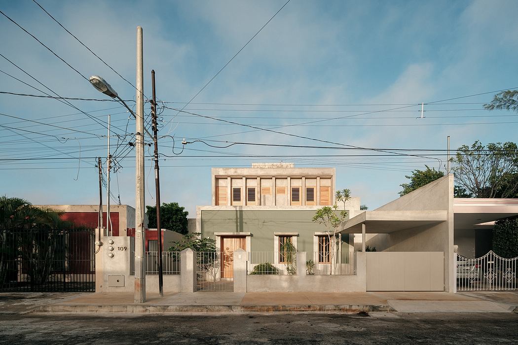 Beige stucco building with decorative shutters and gates, power lines in foreground.
