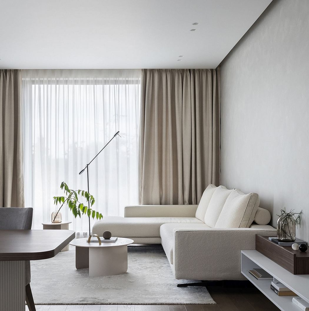 Minimalist living room with neutral palette, plush sofa, and modern furniture pieces.