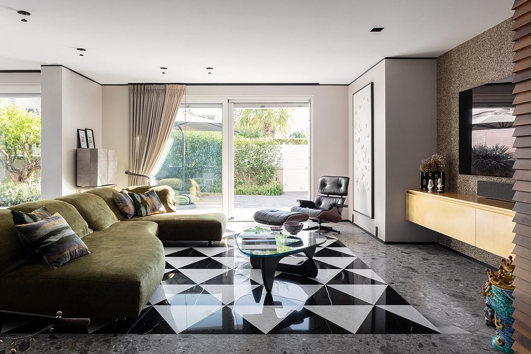 Modern living room with geometric tile flooring, large sofa, and sliding glass door to backyard.
