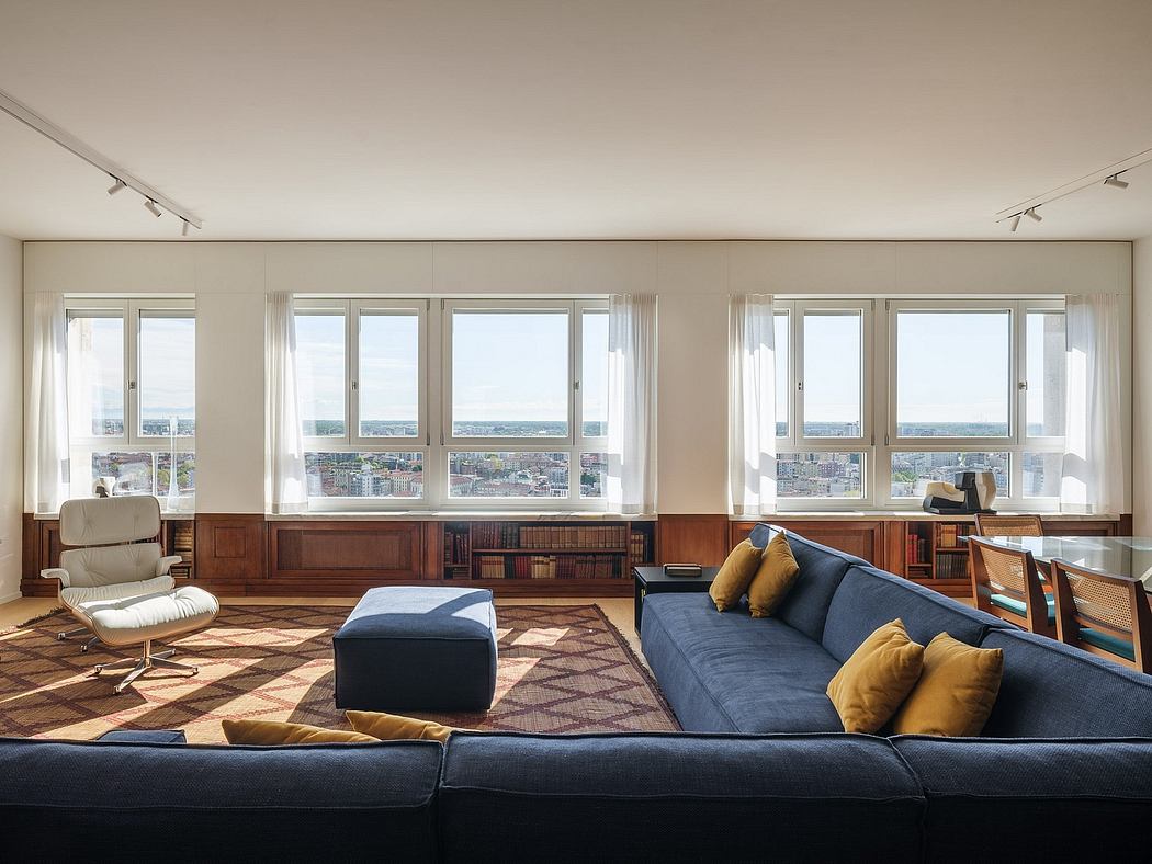 Spacious living room with large windows offering sweeping city views and modern furniture.