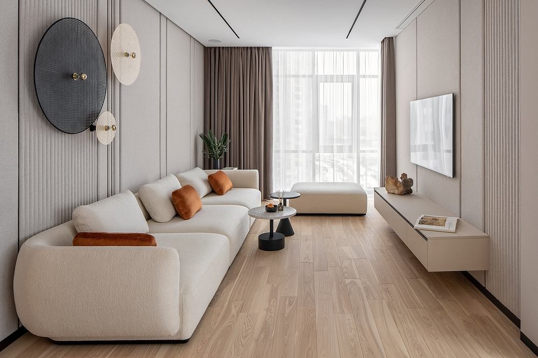 Minimalist living room with neutral-toned furniture, textured wall panels, and wood flooring.