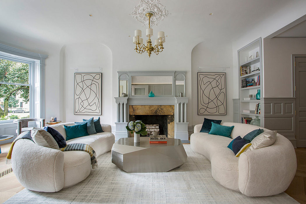 Elegant living room with ornate chandelier, built-in shelving, and abstract wall art.