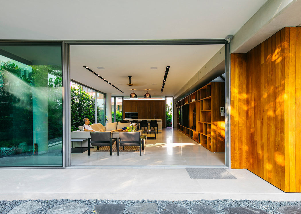 Spacious modern interior with wood-paneled walls, glass walls, and built-in shelves.