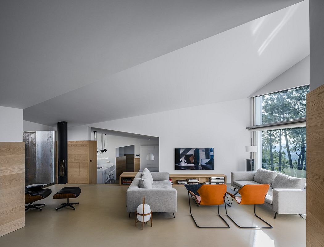 Spacious living room with modern furniture, large windows, and wood accents. Minimalist design.