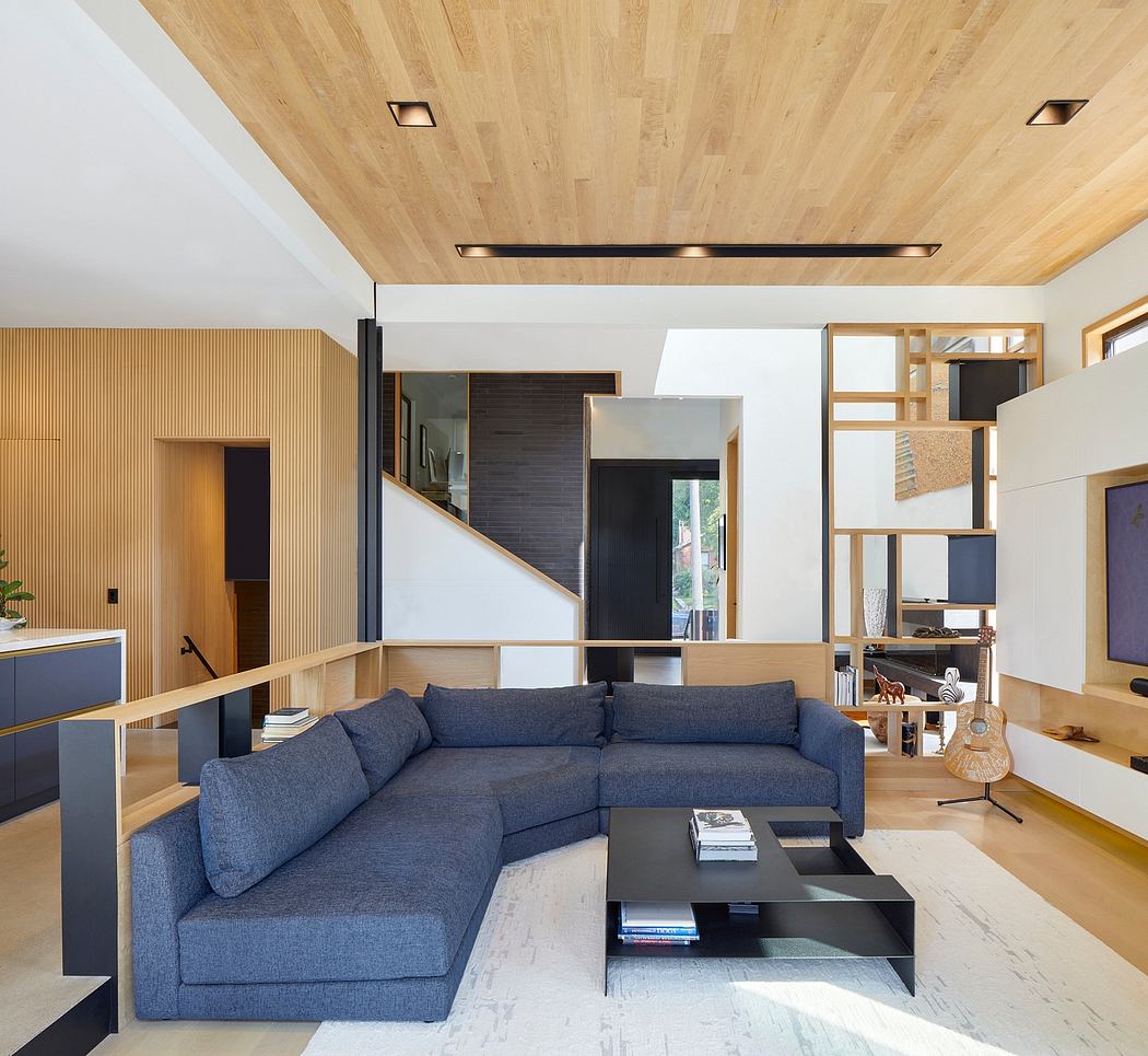 Minimalist living room with wooden ceiling, built-in storage, and stylish sofa.