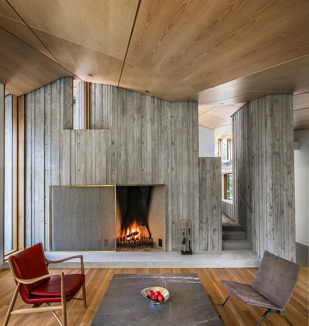 Warm, cozy living room with wood-paneled walls, fireplace, and modern furniture.