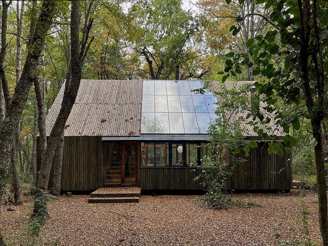 A rustic wooden cabin nestled in a lush forest, with a modern glass facade reflecting the surrounding greenery.