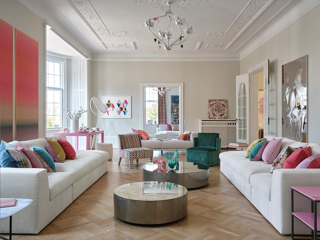 Ornate moldings, color-rich furnishings, and striking coffee tables in a spacious living room.