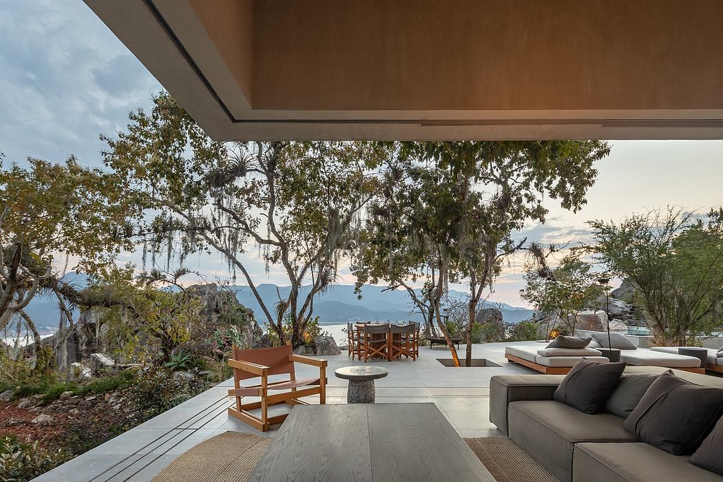 Expansive covered terrace with modern, nature-inspired furnishings and panoramic views.